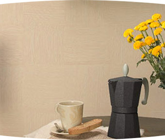 An espresso maker, coffee cup, and flowers sitting on a table